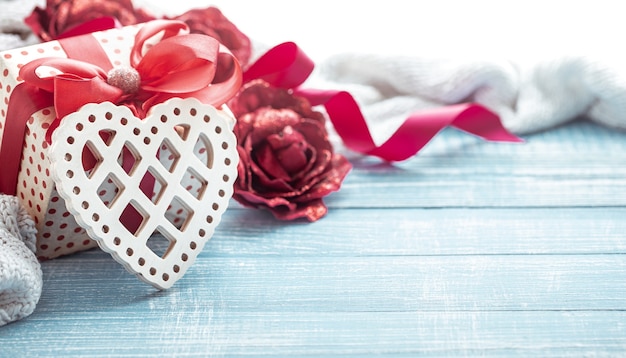 Still life with a gift and wooden decorative heart close up. valentine's day celebration concept.