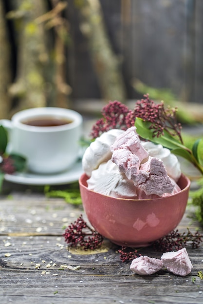 still life with marshmallows in a bowl on wood