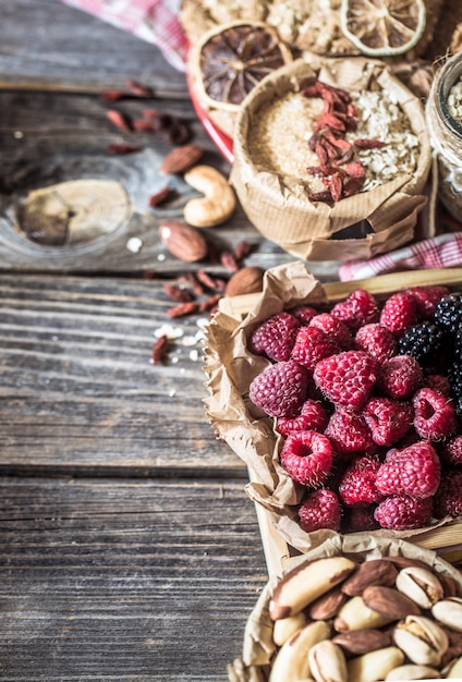 Free photo still life with raspberries and nuts