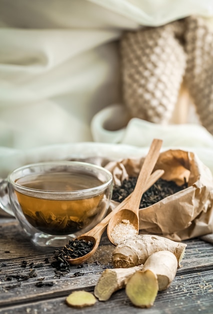 Free photo still life with transparent cup of tea on wooden table