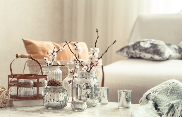 Free photo still life with vases with spring flowers in the living room