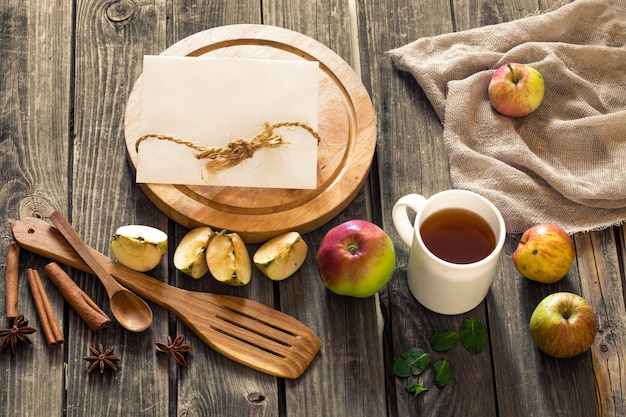 still life of wooden utensils and apples.Place for text on  wall