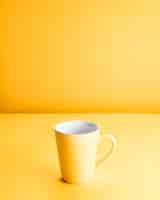 Free photo still life of a yellow mug