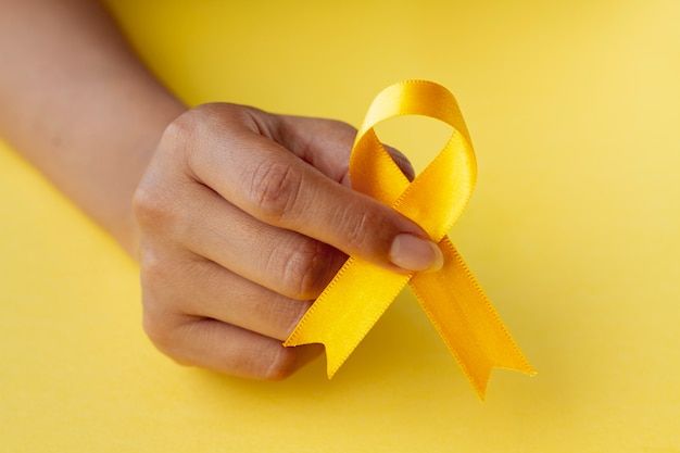 Still life of yellow ribbon in hand