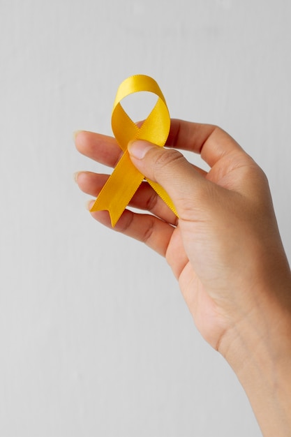 Still life of yellow ribbon in hand