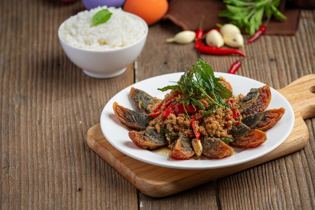 Stir Fried Basil with Spicy Century Egg Served with steamed rice and chili fish sauce, Thai food.