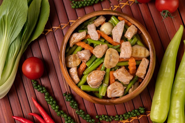 Stir-fried mixed vegetables containing Green peas, carrots, mushrooms, corn, broccoli, and pork