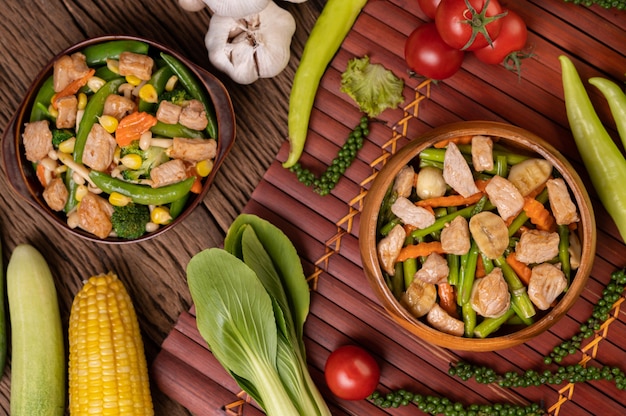 Stir-fried mixed vegetables containing Green peas, carrots, mushrooms, corn, broccoli, and pork