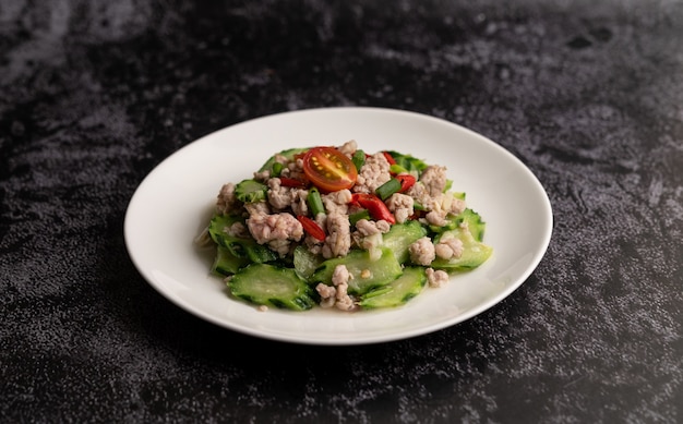 Stir fried zucchini with minced pork in white plate