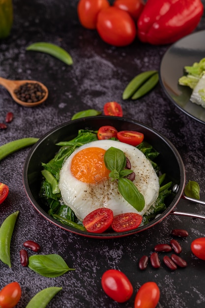 Stir kale and fried egg in a pan.