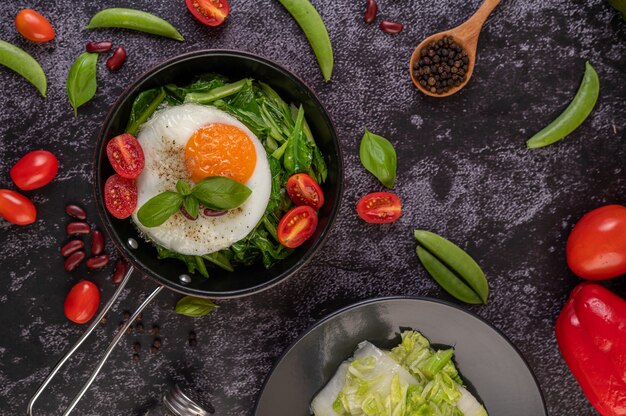 Stir kale and fried egg in a pan.