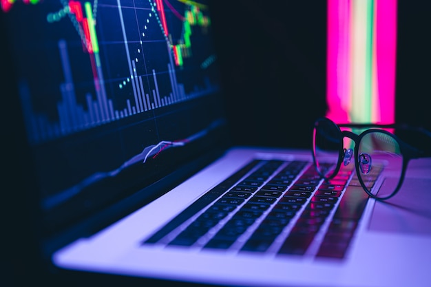 Stock market graph financial data on an electronic board on a laptop screen