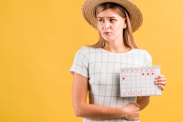 Stomach cramps and period calendar medium shot