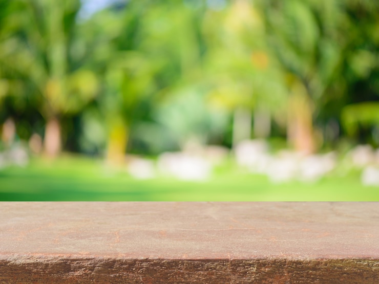 Free Photo stone board empty table in front of blurred background. perspective brown stone over blur trees in forest