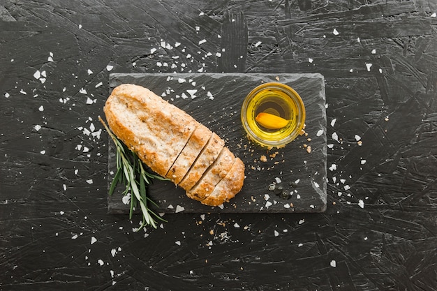 Free photo stone board with bread and oil