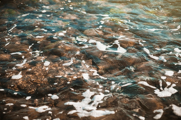 Free photo stones under waving water