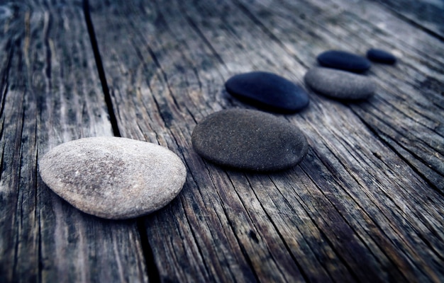 Free photo stones wooden table group of objects concept