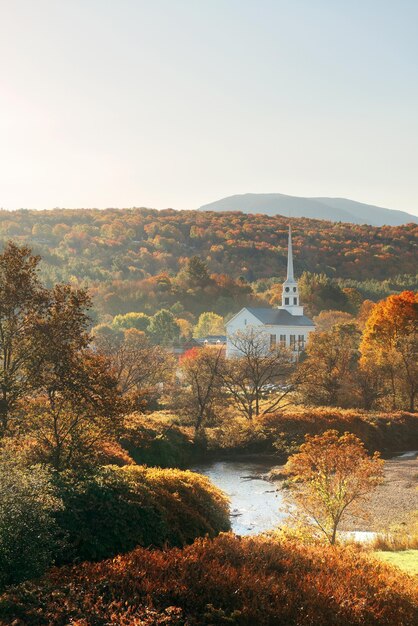 Stowe morning in Autumn with colorful foliage and community church in Vermont