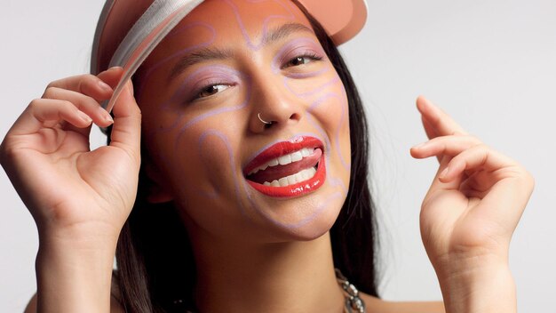 Straight crop head and shoulders mixed race asian model in the studio on white with ideal glowy skin natural makeup Closeup portrait smiling with tongue out