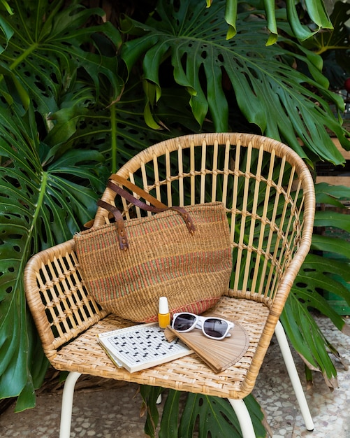 Straw chair and travel items arrangement