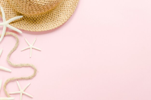 Straw hat with sea stars on table