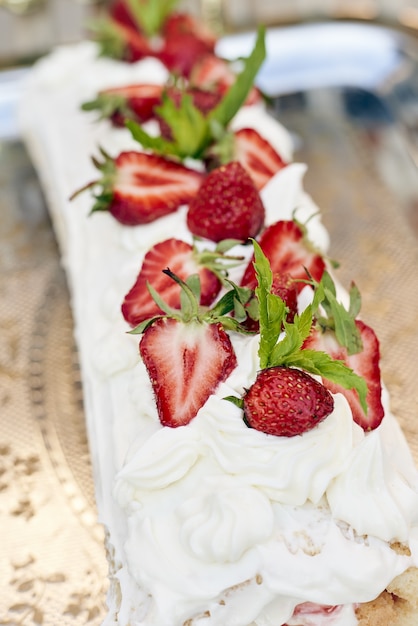 Strawberries on a cake with white cream