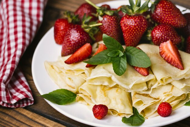 Strawberries and crepes close up