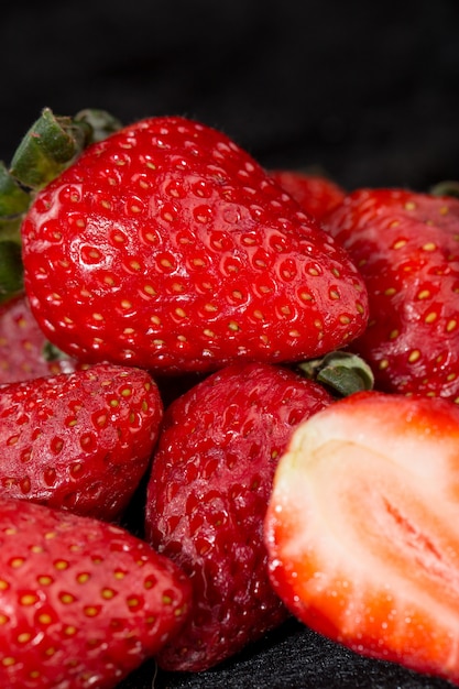 Strawberries red juicy mellow ripe isolated on grey desk