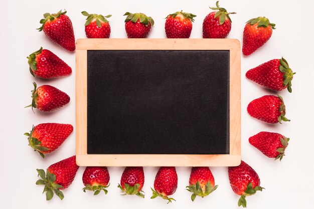 Strawberry and blackboard in center 