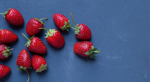 Strawberry demonstration on a blue table. 