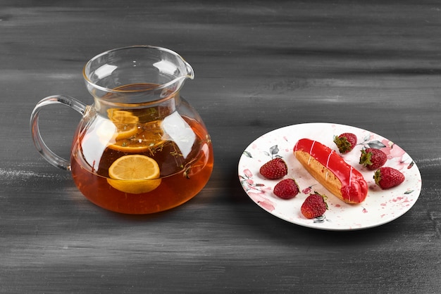 Strawberry eclair with a jar of drink.