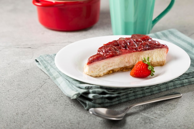 테이블에 흰색 식기에 딸기 유약 치즈 케이크