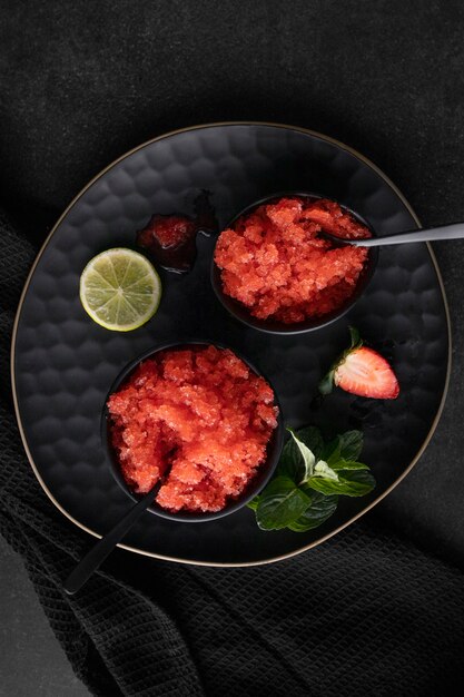 Strawberry granita dessert with lime flat lay