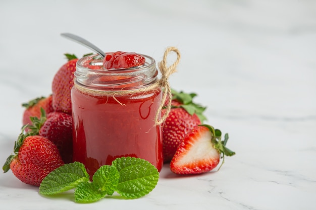 Strawberry jam on marble background