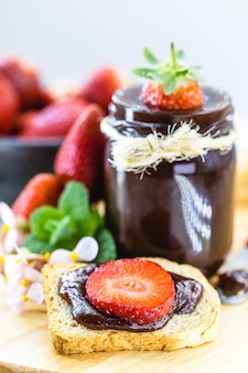 Strawberry jam with pieces of fruit, organic strawberries