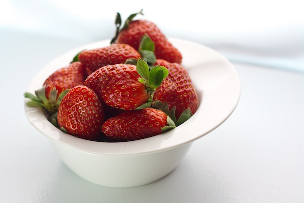 Strawberry lays on white dish