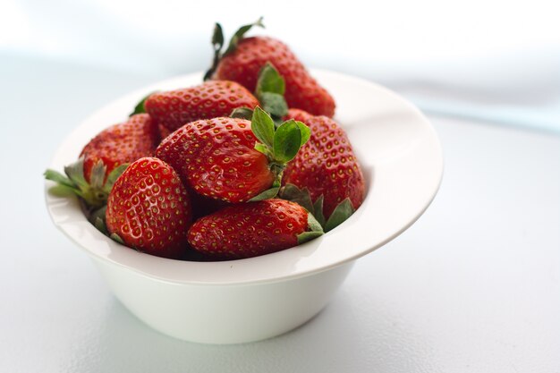 Strawberry lays on white dish