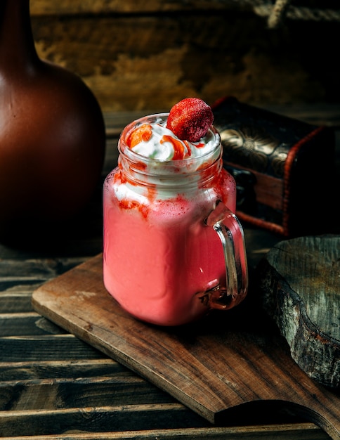 Strawberry milkshake topped with strawberry