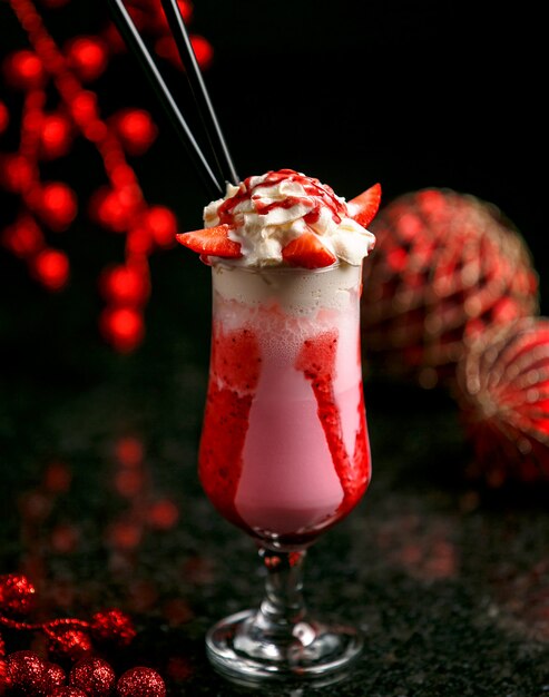 Strawberry milkshake with ice on the table
