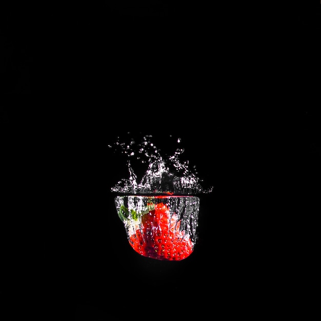 Strawberry plunging into the water