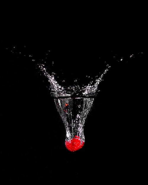 Strawberry plunging into the water