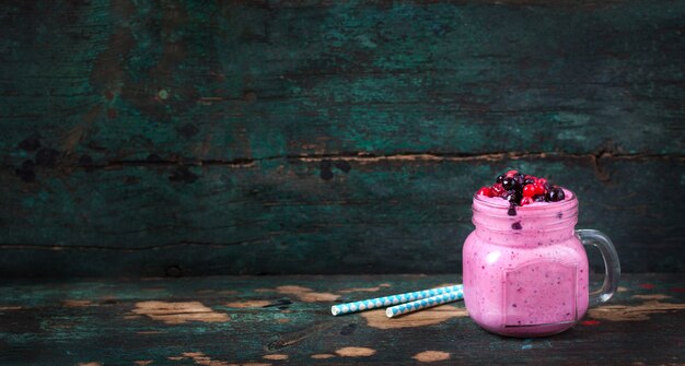 Strawberry smoothie with wooden background