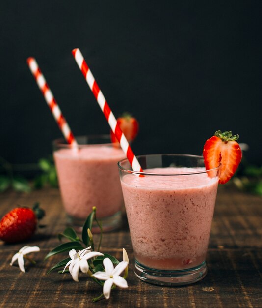 Strawberry smoothies next to flowers