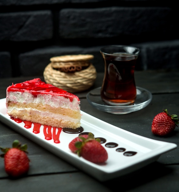 Strawberry syrup custard sponge cake and a cup of flavored tea