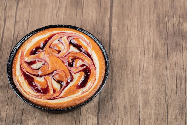 Strawberry syrup pie on black metallic pan.