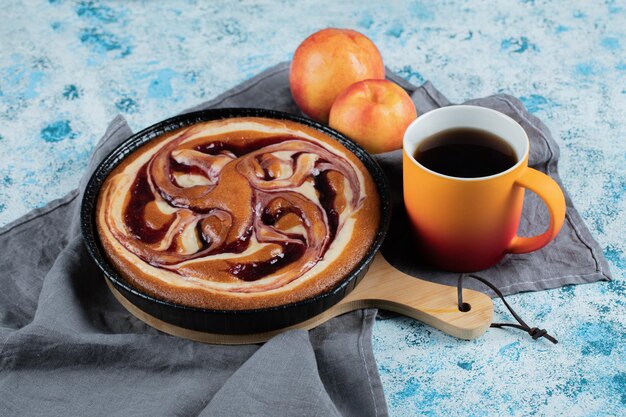 Strawberry syrup pie served with a cup of tea.