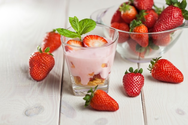 Strawberry yogurt and granola in glass