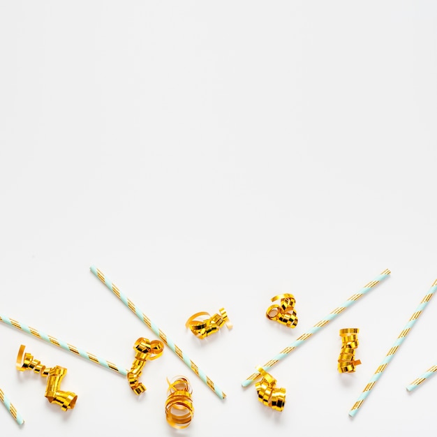 Straws and golden ribbons with copy space background