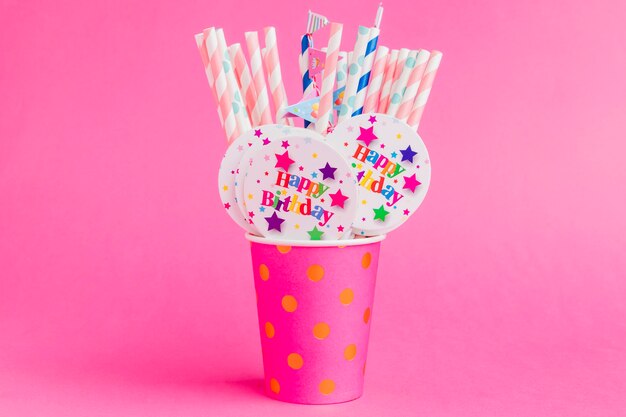 Straws with badges in cup