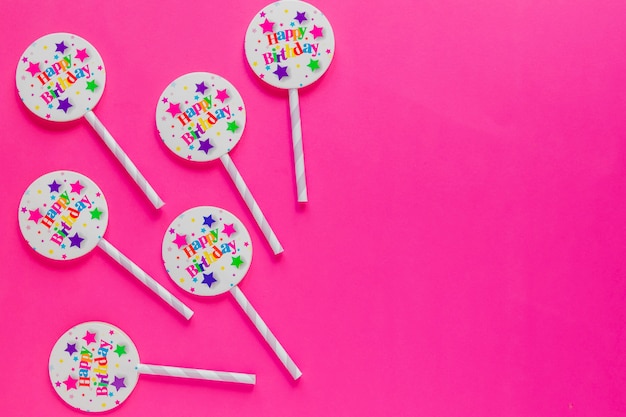 Straws with badges on pink